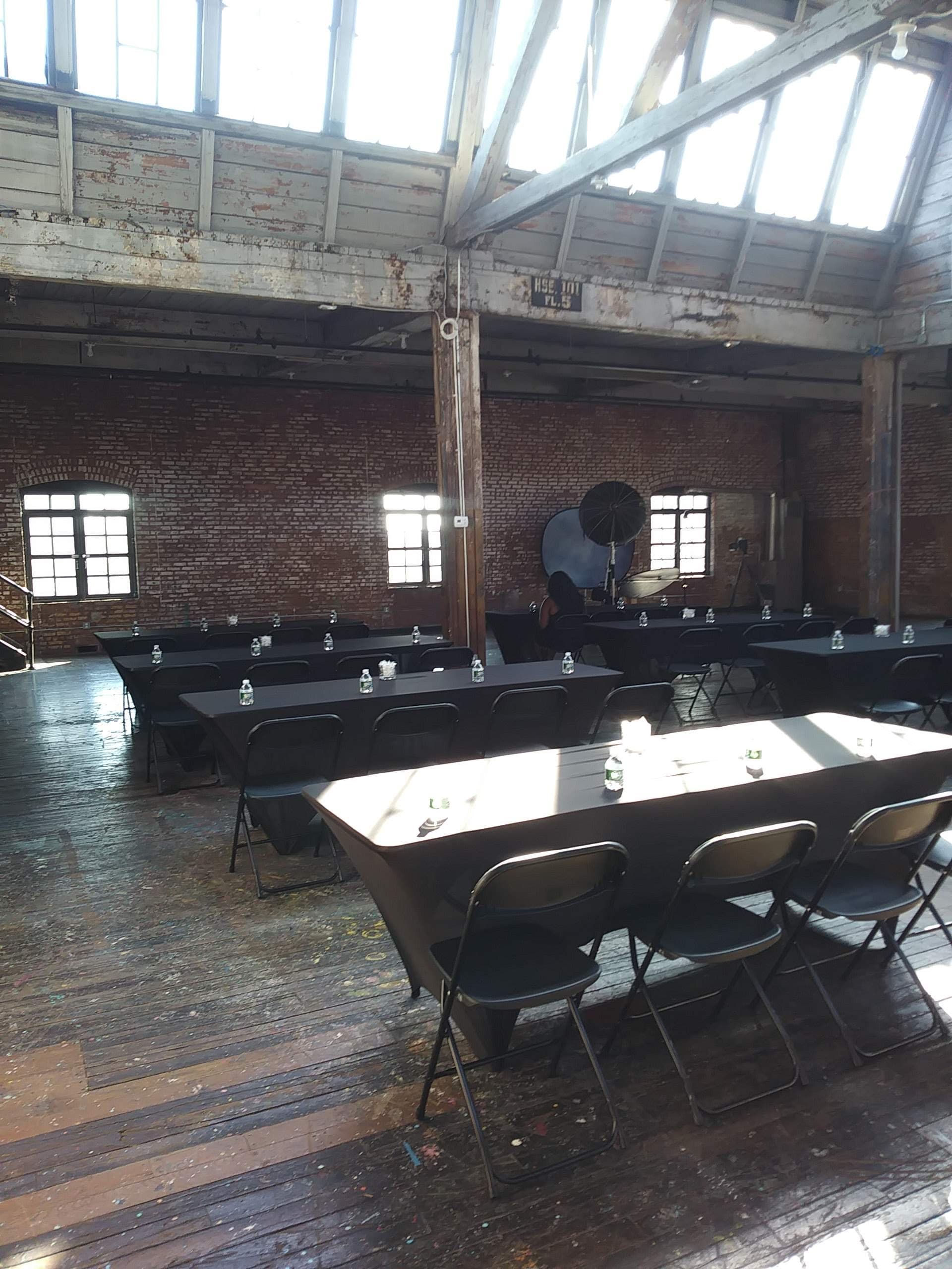 Industrial loft classroom set with black linens for a corporate workshop