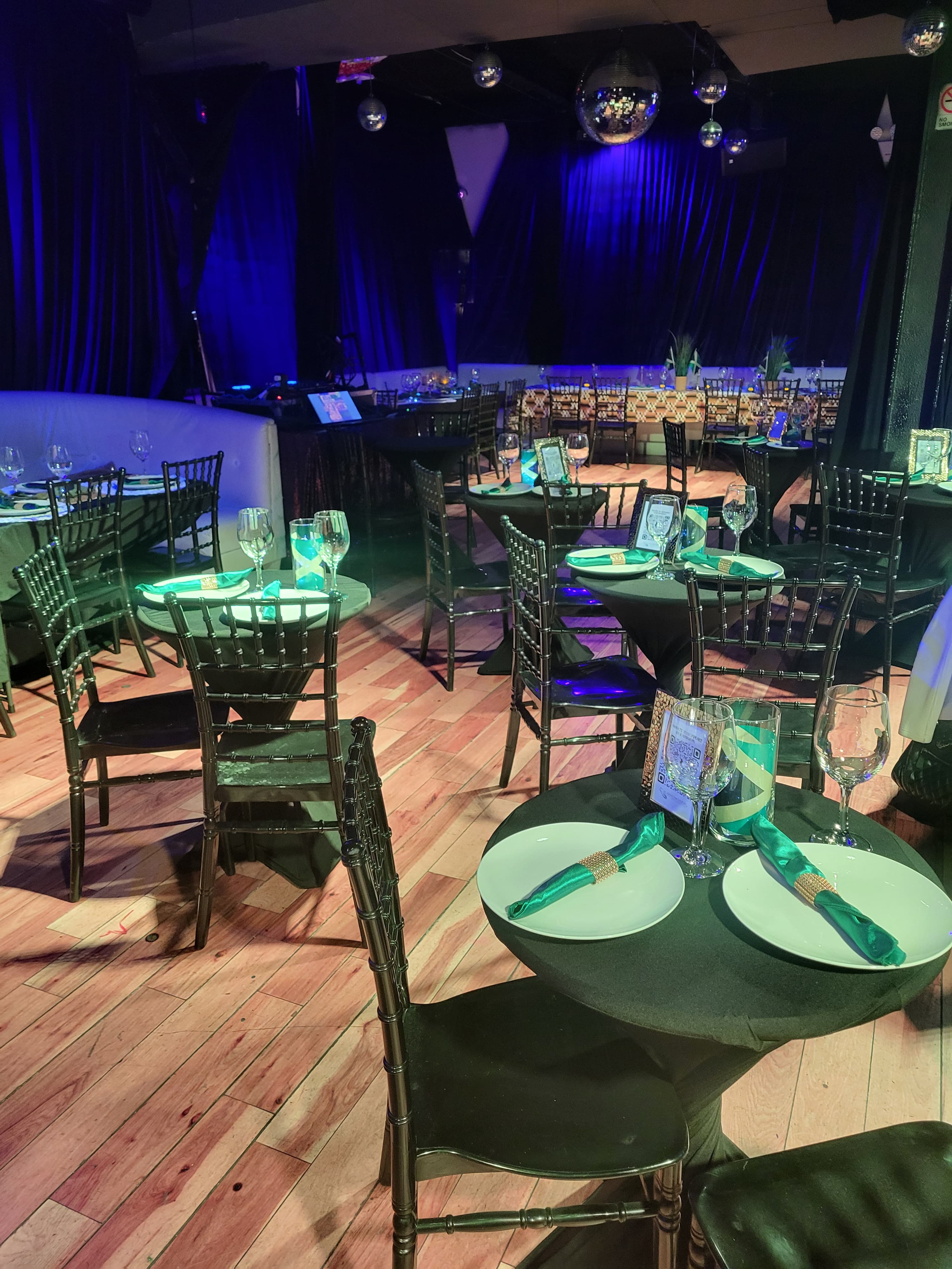 Stage and guest tables ready for a live music corporate dinner