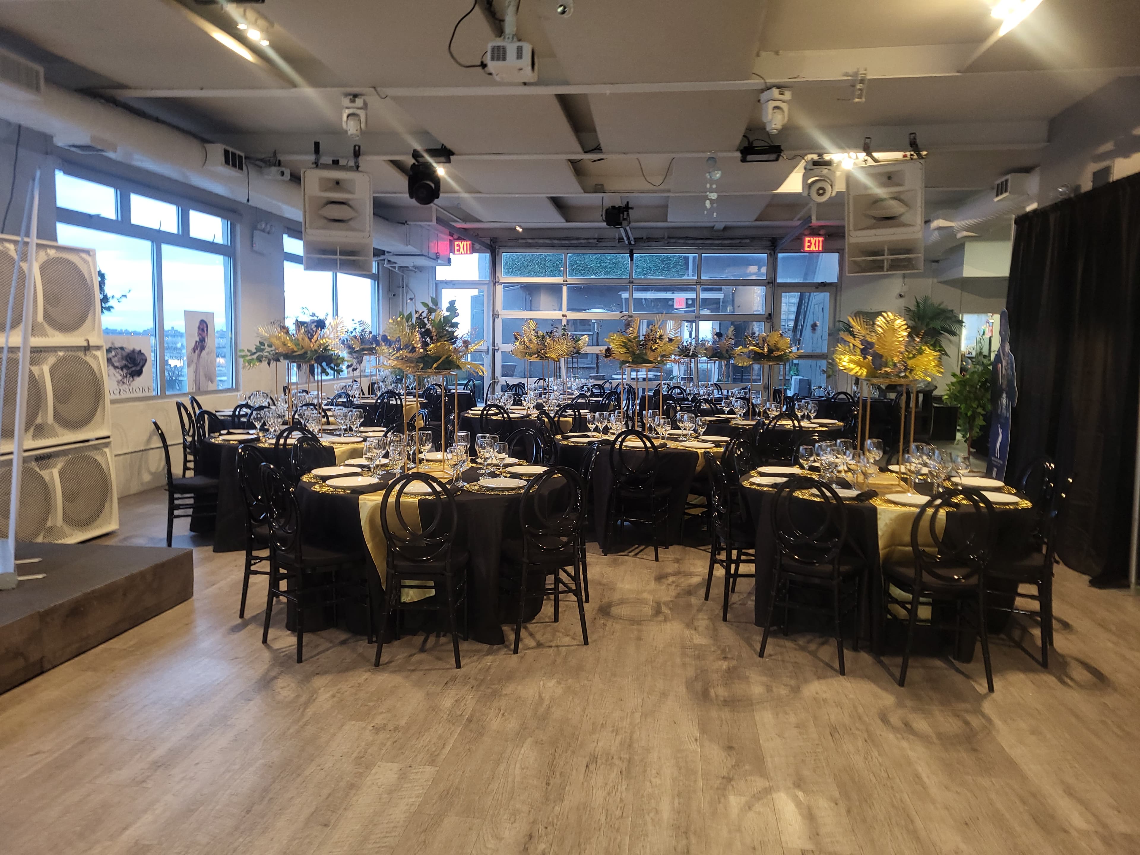 Corporate event loft with black linens and elevated floral centerpieces by Flow C Inc.