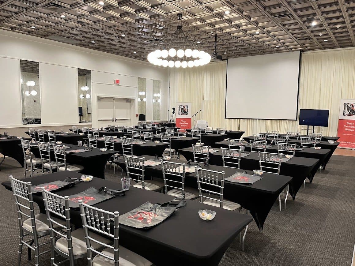 Classroom-style meeting room prepared with projection and attendee materials